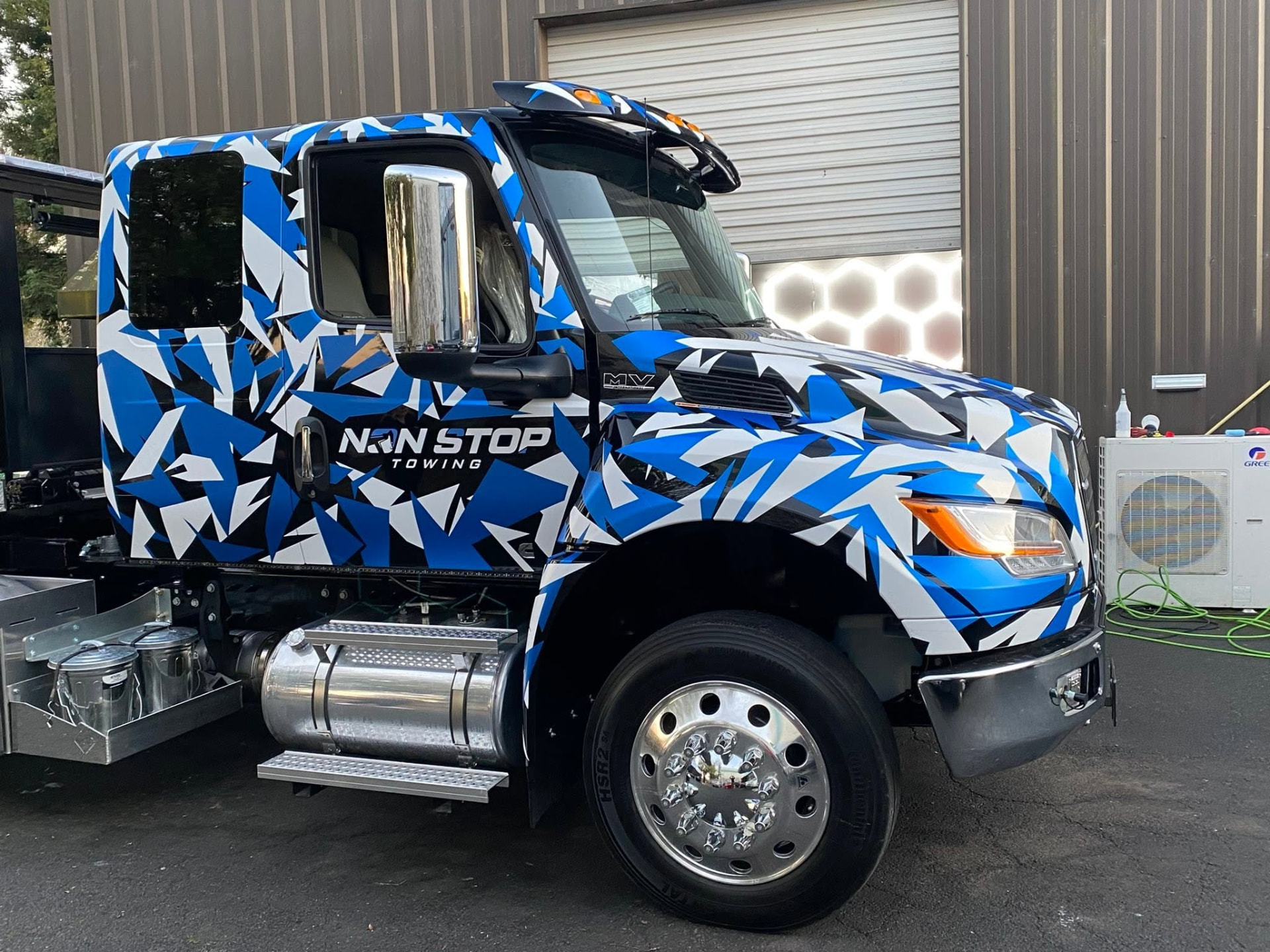 Non Stop Towing heavy-duty rotator wrecker at dusk on a Sonoma County highway
